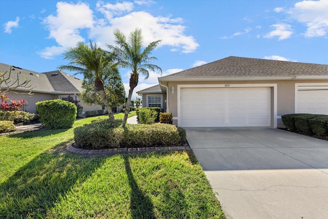 single story home with a front yard and a garage