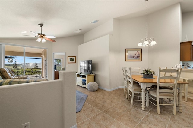 tiled dining area featuring ceiling fan with notable chandelier