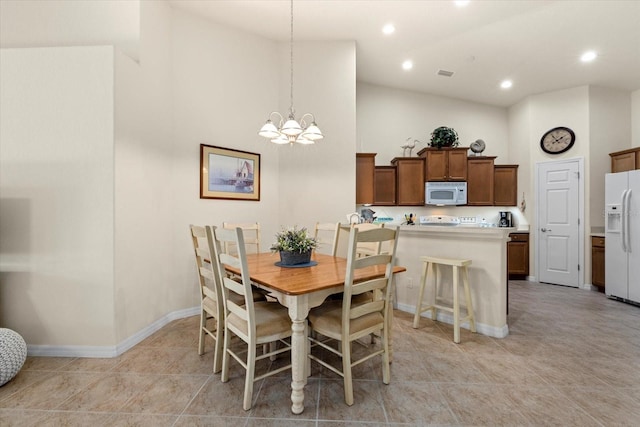 tiled dining area featuring high vaulted ceiling and a notable chandelier