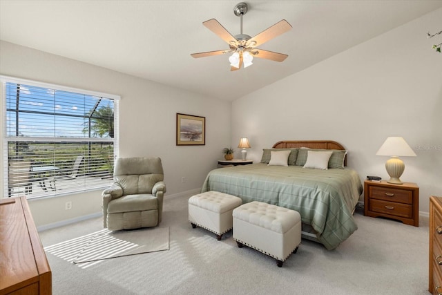 carpeted bedroom with ceiling fan and vaulted ceiling