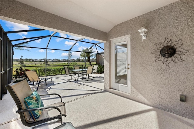 view of patio featuring a lanai