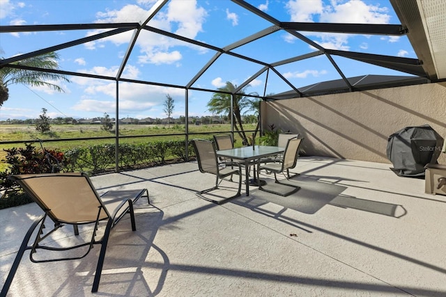 view of patio featuring a rural view, area for grilling, and a lanai