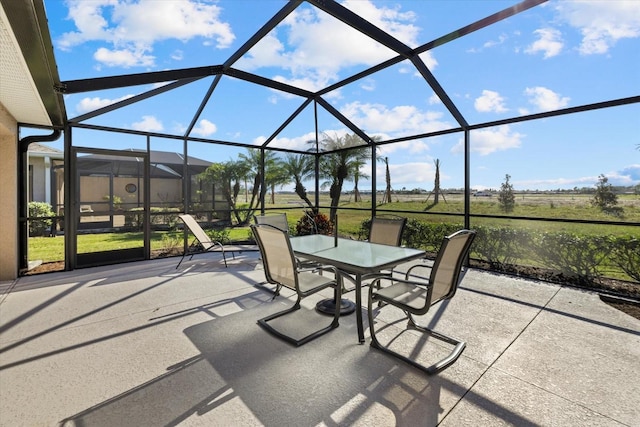 view of patio / terrace featuring glass enclosure