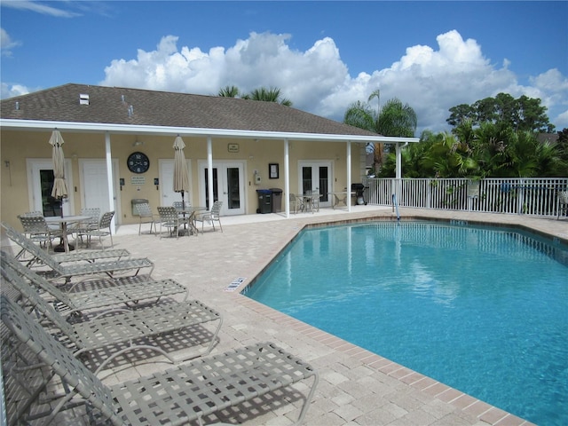 view of swimming pool with a patio area and french doors