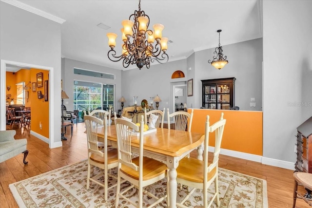 dining area featuring crown molding and light wood-type flooring