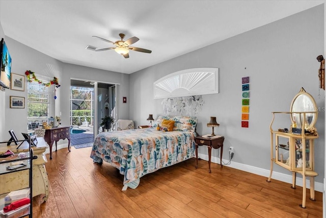 bedroom with light wood-type flooring, access to outside, and ceiling fan