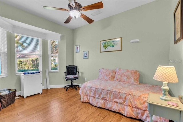 bedroom with ceiling fan and light wood-type flooring