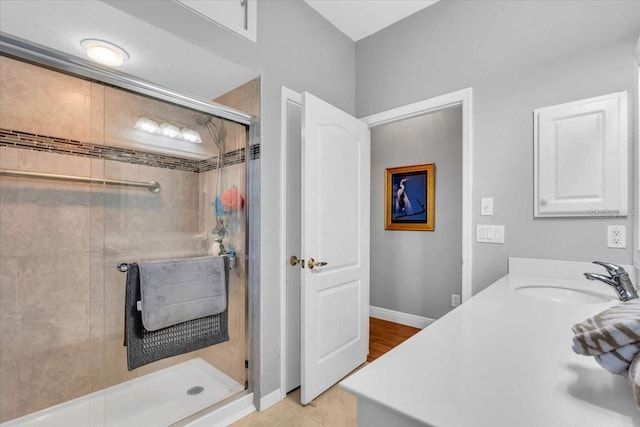 bathroom featuring vanity, tile patterned floors, and a shower with door