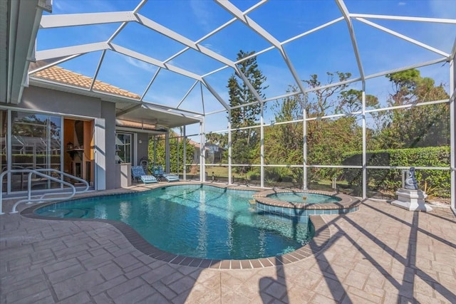 view of pool with an in ground hot tub, a patio, and glass enclosure