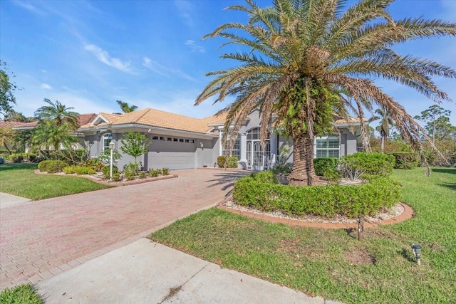 view of front of home with a garage and a front lawn