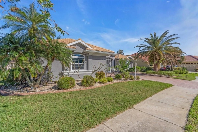 mediterranean / spanish-style home featuring a front yard