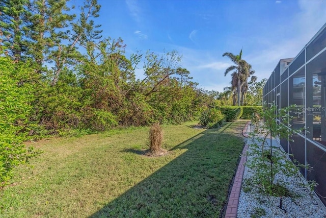 view of yard featuring glass enclosure