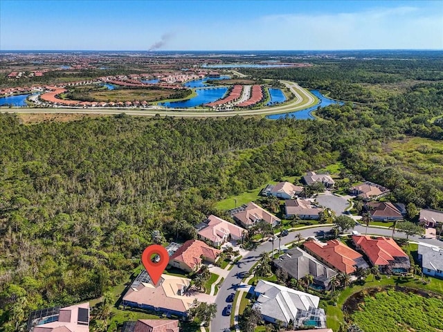 birds eye view of property with a water view