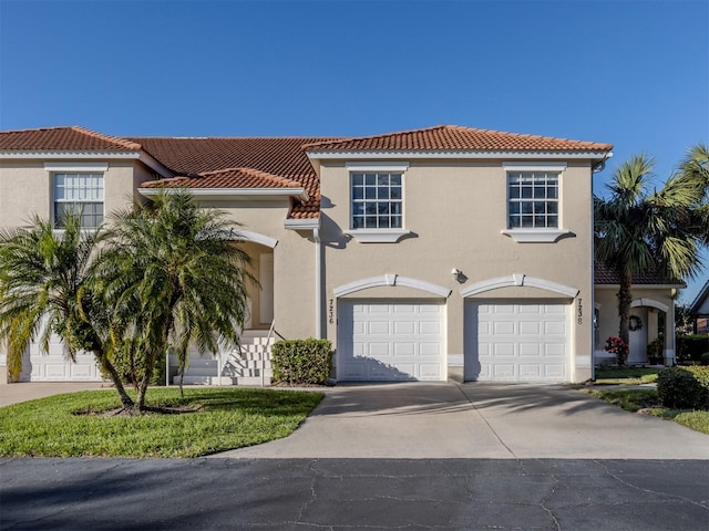 mediterranean / spanish home featuring a garage