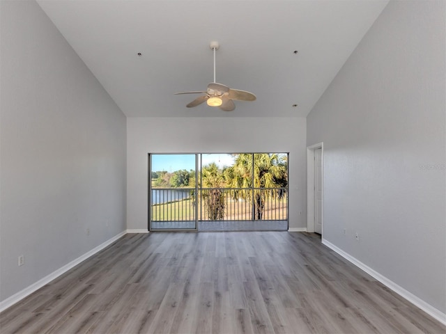 unfurnished room with ceiling fan, light hardwood / wood-style flooring, and high vaulted ceiling