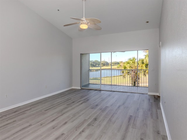 spare room with a water view, ceiling fan, and light hardwood / wood-style floors