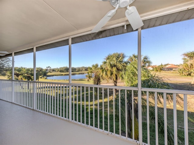 sunroom with a water view, plenty of natural light, and ceiling fan