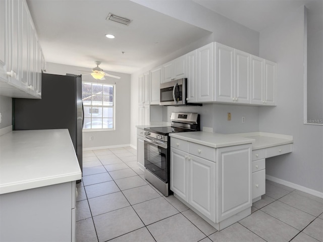 kitchen with ceiling fan, white cabinetry, stainless steel appliances, and light tile patterned floors