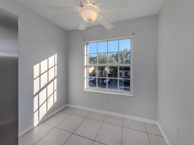 spare room with light tile patterned floors and ceiling fan