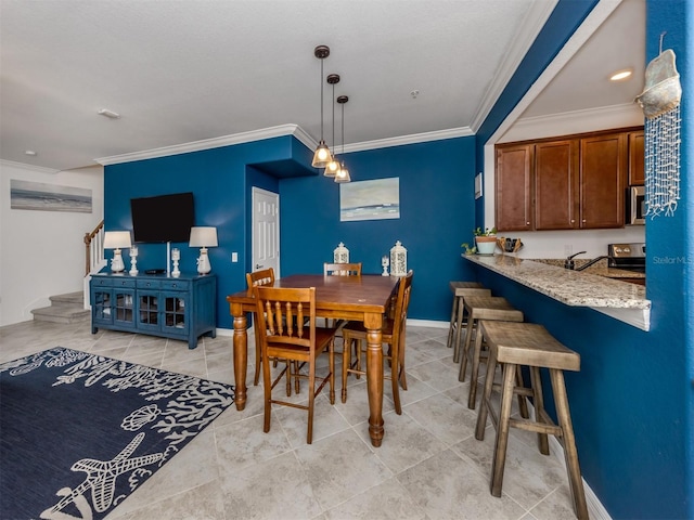 dining area featuring ornamental molding and light tile patterned flooring