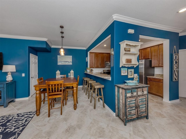 kitchen featuring pendant lighting, kitchen peninsula, crown molding, and appliances with stainless steel finishes