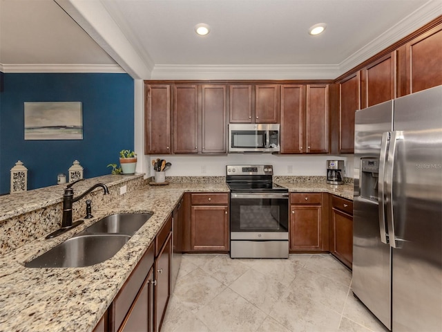 kitchen with kitchen peninsula, light stone counters, ornamental molding, stainless steel appliances, and sink