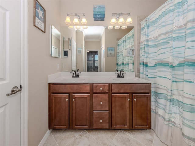 bathroom featuring tile patterned flooring, vanity, and ornamental molding