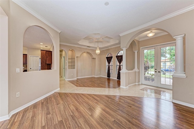 foyer entrance with crown molding, french doors, a textured ceiling, and light hardwood / wood-style flooring