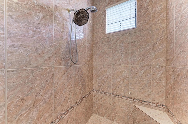 bathroom with tiled shower