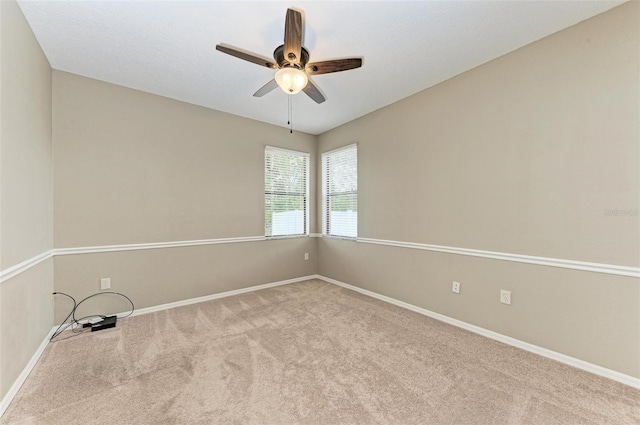 carpeted empty room featuring ceiling fan