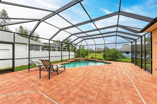 view of swimming pool featuring pool water feature, a patio area, and a lanai