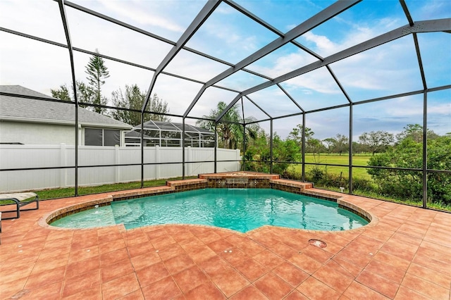 view of pool featuring glass enclosure and a patio