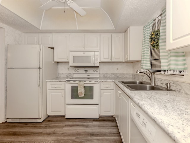 1708 Bonitas Cir Unit 1726A, Venice, FL 34293 - kitchen featuring white appliances, a sink, white cabinetry, wood finished floors, and a textured ceiling