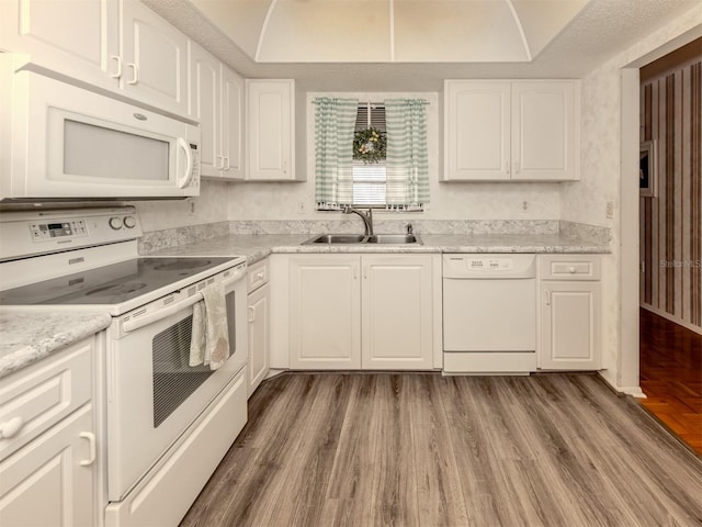 1708 Bonitas Cir Unit 1726A, Venice, FL 34293 - kitchen featuring white appliances, a sink, white cabinets, and wood finished floors