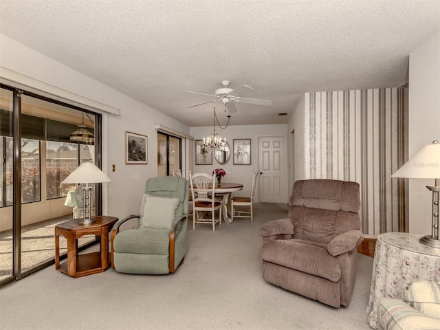 living room with carpet, a textured ceiling, and ceiling fan