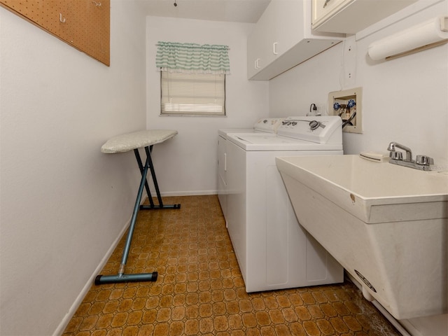 1708 Bonitas Cir Unit 1726A, Venice, FL 34293 - washroom featuring cabinet space, washing machine and clothes dryer, and baseboards
