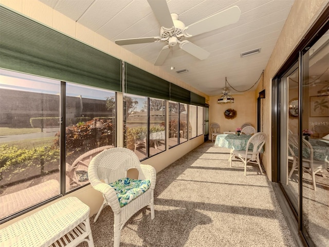 sunroom featuring ceiling fan