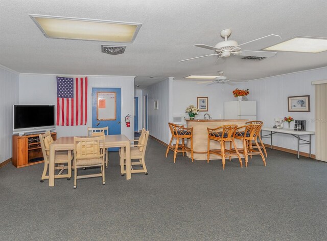 1708 Bonitas Cir Unit 1726A, Venice, FL 34293 - dining area featuring a ceiling fan, carpet, a textured ceiling, and crown molding