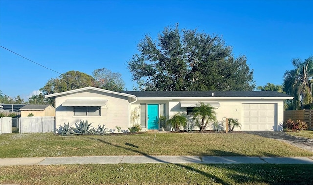 view of front of home with a front yard and a garage