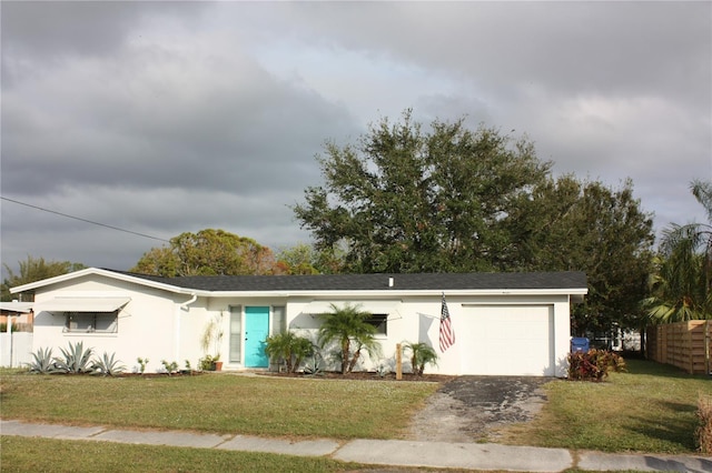 single story home with a front yard and a garage