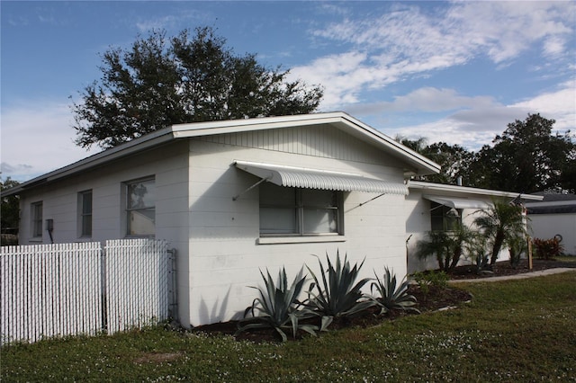 view of home's exterior with a yard