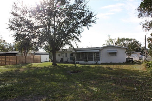 back of property featuring a yard