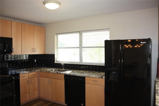 kitchen with decorative backsplash, a wealth of natural light, black appliances, and dark hardwood / wood-style floors