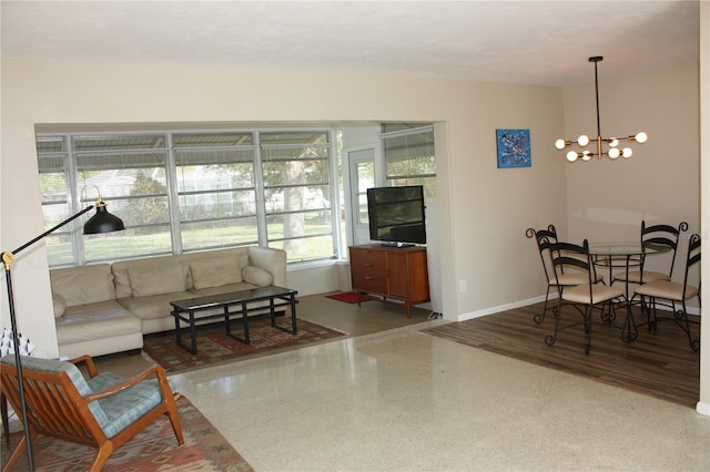 living room with a textured ceiling and a notable chandelier