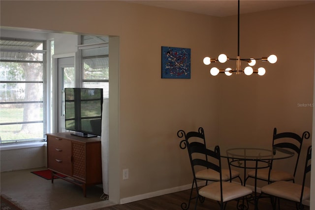 dining area featuring wood-type flooring and a chandelier