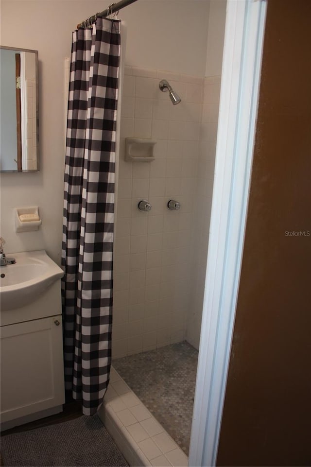 bathroom with tile patterned floors, curtained shower, and vanity