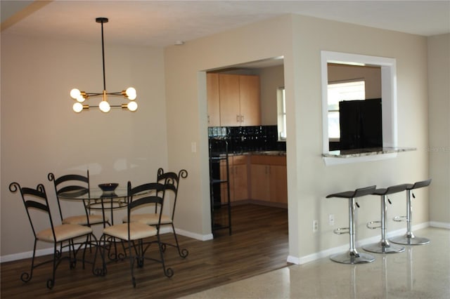 dining room featuring dark hardwood / wood-style floors and a chandelier