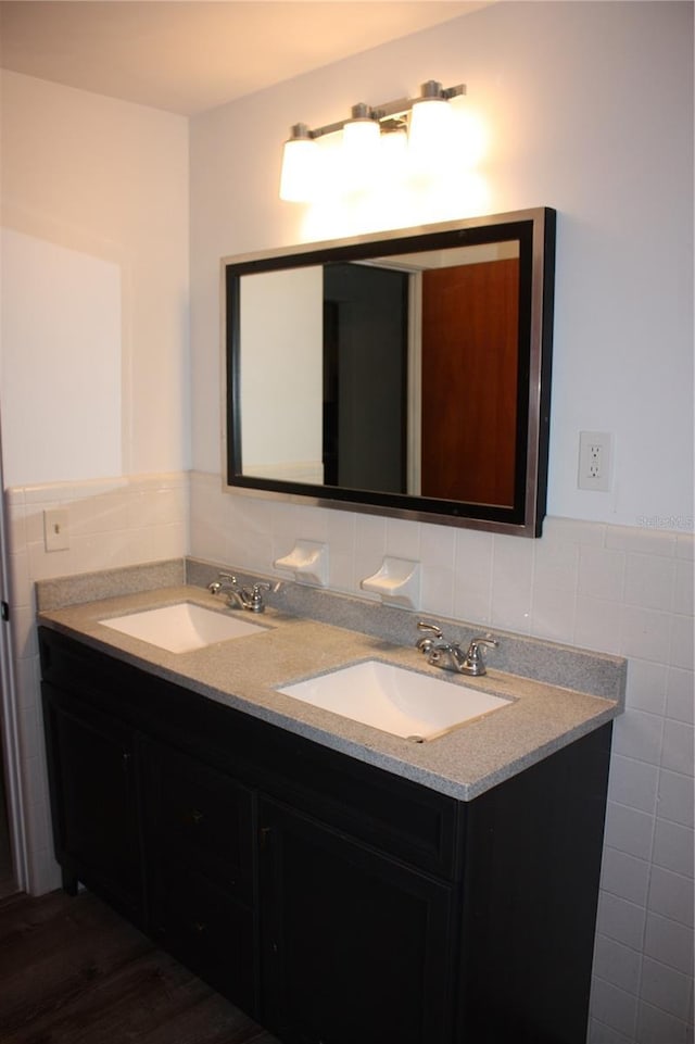 bathroom featuring hardwood / wood-style floors, vanity, and tile walls