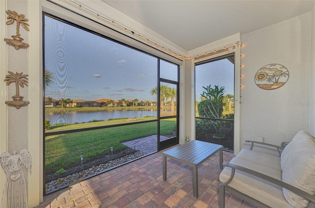 sunroom / solarium with a water view