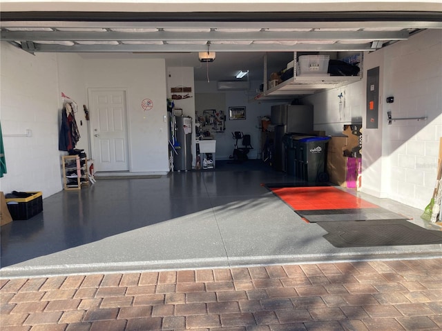 garage featuring electric panel and a garage door opener